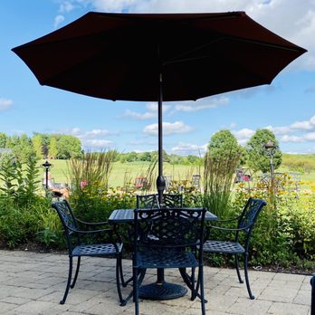 The Oak Terrace Grille - a table and chairs under an umbrella - American Near Me - Barrington, Illinois
