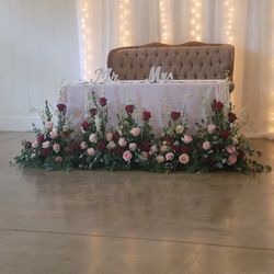 Carey's Cassville Florist - Beautiful roses of different colors adorning the bride and groom table