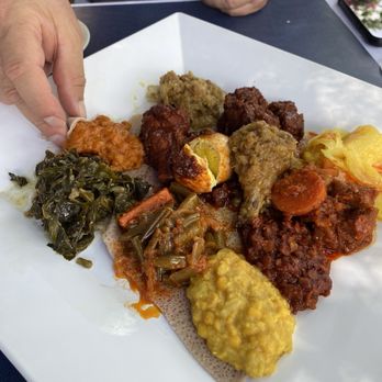 Das Ethiopian - This is the vegetable combination plate alongside a meat combination plate to be eaten family style. - Ethiopian Near Me - Washington, DC, District of Columbia