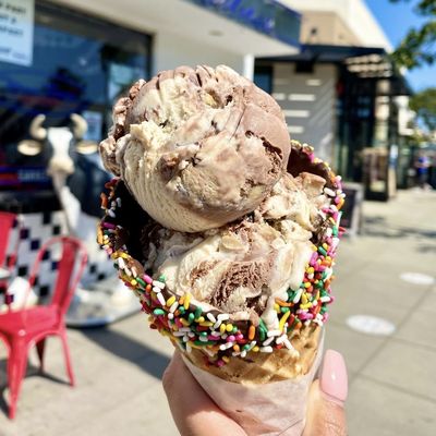 Photo of MooTime Creamery - Coronado, CA, US. A big moo in a dipped waffle cone with Scoop There It Is ice cream!