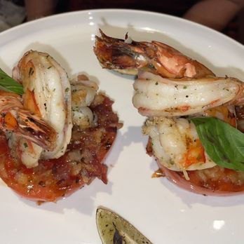 Carnival Conquest - Jumbo Shrimp on a bed of sliced tomatoes - Travel Services Near Me Carnival Conquest - Jumbo Shrimp on a bed of sliced tomatoes - Travel Services Near Me