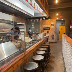 Taqueria Picoso - Kitchen area and seats where you can watch them prepare. Nice and clean, organized.