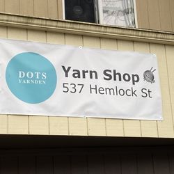 Dot's Yarn Den - Sign on the building.