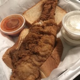 Fish sandwich, tartar sauce, slaw and hot sauce on Texas Toast. Fish sandwich, tartar sauce, slaw and hot sauce on Texas Toast.