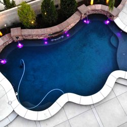 Paradise Pools & Spas - Aerial shot of a beautiful custom pool with lighting and water feature.  Designed and built by Paradise Pools & Spas in Bakersfield, CA.