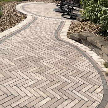 Outdoor Oasis Landscaping - Full view of the completed paver walkway and seating area, showcasing the seamless transition between the pathway and entertainment section. - Lawn Services Near Me