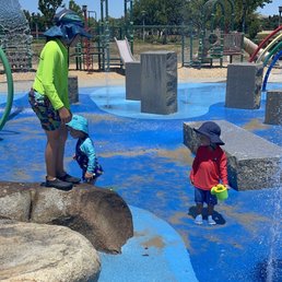 Splash pad surrounded by playgrounds Splash pad surrounded by playgrounds