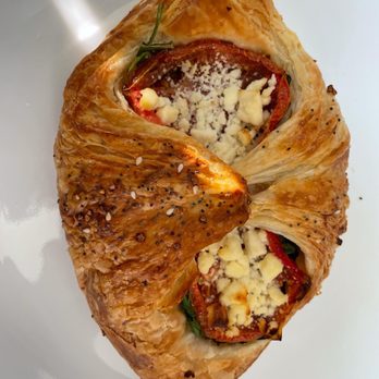 Sunflour Baking Company - a croissant with tomatoes and cheese - Bakeries Near Me - Harrisburg, North Carolina