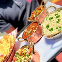 Lotus Cuisine of India - Served hot in copper pots: rich curries, fragrant peas pulao, and fresh naan. Dinner is served.