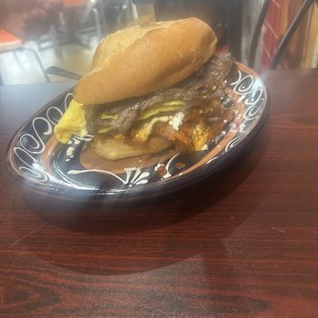 Mexico City Kitchen - Torta de chilaquiles rojas with chicken + steak + 2 scrambled eggs. - Mexican Near Me - Speedway, Indiana Mexico City Kitchen - Torta de chilaquiles rojas with chicken + steak + 2 scrambled eggs. - Mexican Near Me - Speedway, Indiana