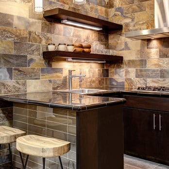 The Tile Shop - a kitchen with a counter and stools - Tiling Near Me - Dallas, Texas The Tile Shop - a kitchen with a counter and stools - Tiling Near Me - Dallas, Texas