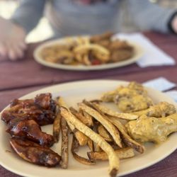 Thelma’s Wangs & Thangs - Sweet Bbq, fries, garlic Parmesan in the front Butter, fries, and Tia breaded in the back