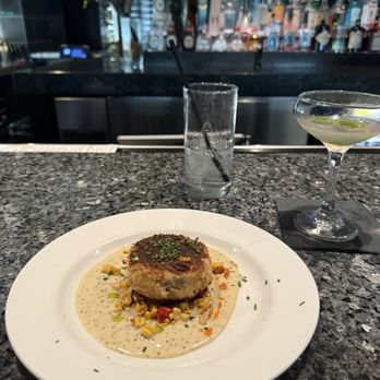 Ray's On the River - Crabcake sitting on delicious sauce with fresh corn! - Seafood Near Me - Sandy Springs, Georgia Ray's On the River - Crabcake sitting on delicious sauce with fresh corn! - Seafood Near Me - Sandy Springs, Georgia
