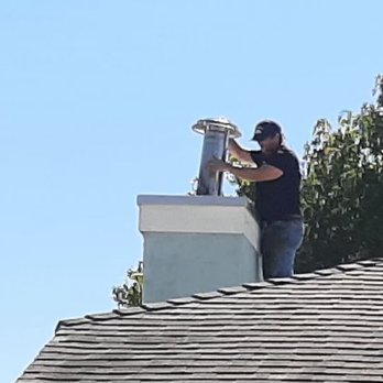 VenturaCo Chimney Pros - Sean installing spark arrestor to flue pipe - Chimney Sweeps Near Me