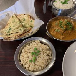 Butter chicken, white and brown rice, garlic cilantro naan. Butter chicken, white and brown rice, garlic cilantro naan.