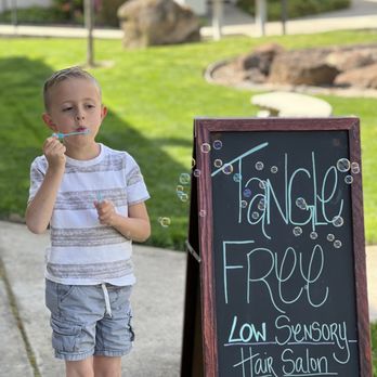 Tangle Free - Marcus enjoying his prize outside after a successful haircut. - Hair Salons Near Me - Carmichael, California