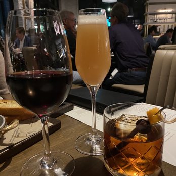 OLIVIA - Our first round. I had the "o" fashioned, on the right-it came with a thin "stirring stick" of dark chocolate - Italian Near Me - Tampa, Florida