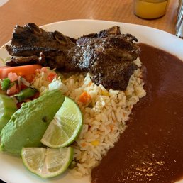 Costillas with rice, pico de gallo, avocado and red beans. Costillas with rice, pico de gallo, avocado and red beans.
