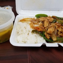 a takeout container with rice and vegetables a takeout container with rice and vegetables