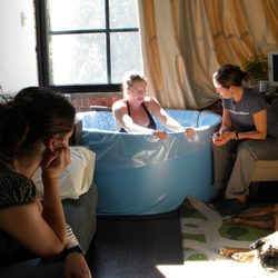 Tara Kenny at Boston Community Midwifery and Doulas - Waiting patiently as a mom has a water birth