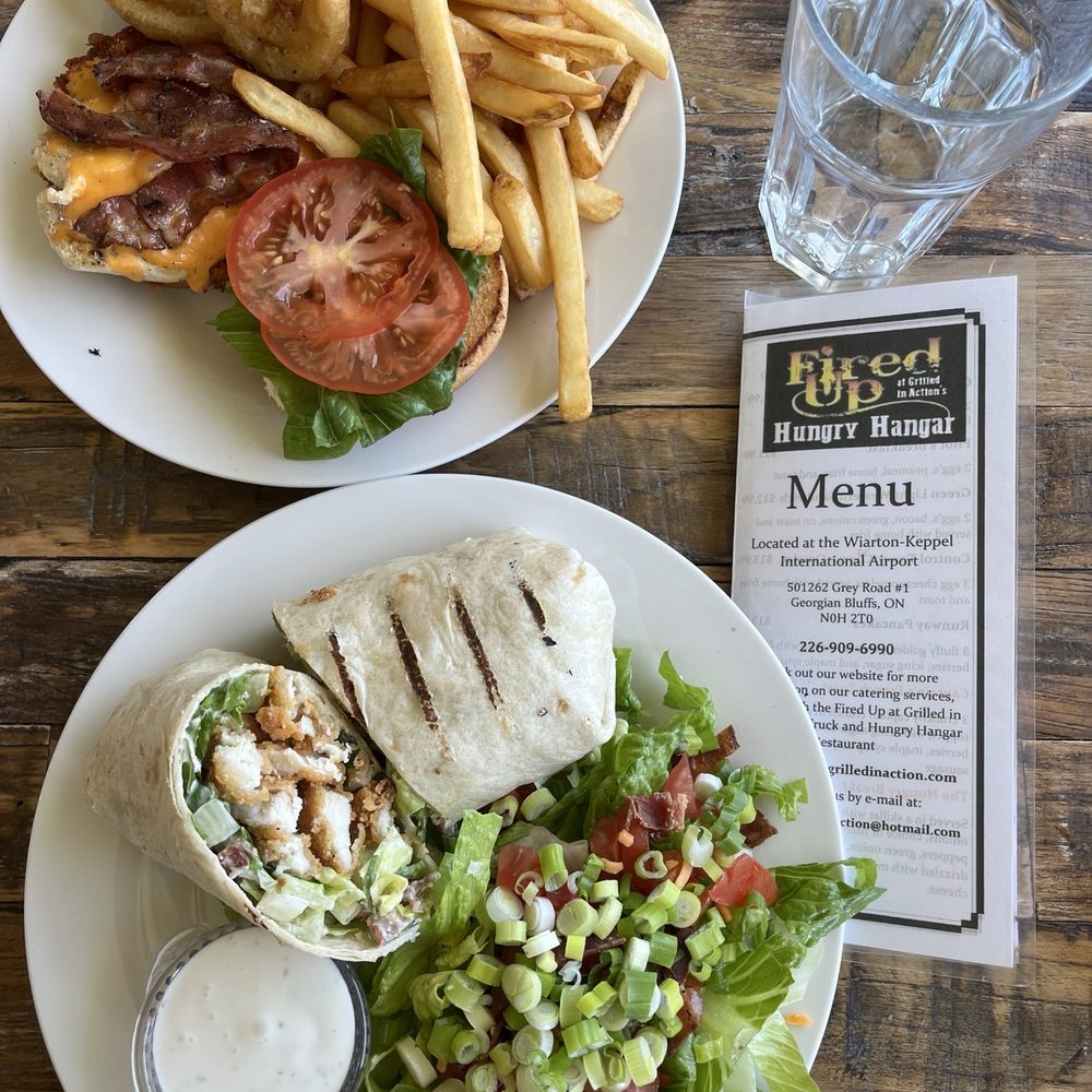 Hungry Hanger - Boarding pass banquet burger (4/5) with fries and onion rings. International Chicken Cesar Wrap (4/5) with side salad. - Diners Near Me - Wiarton, Ontario