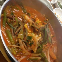 Tiny Town Carry Out - Yook gae jang. Spicy broth consisting of bean sprouts, green onions, onions, shredded beef, and vermicelli noodles.