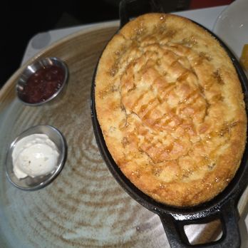 Roots Southern Table - Cast Iron Cornbread with butter and strawberry rhubarb chutney - Southern Near Me - Farmers Branch, Texas Roots Southern Table - Cast Iron Cornbread with butter and strawberry rhubarb chutney - Southern Near Me - Farmers Branch, Texas