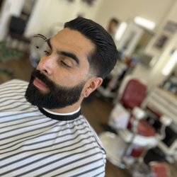 Don Juan's Barbershop - Tapered haircut with clean beard line.