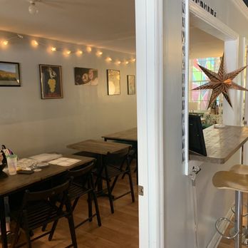 Chatham Street Wine Market - a woman sitting at a table - Wine Bars Near Me - Cary, North Carolina