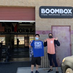 Two people in front of a gym Two people in front of a gym