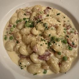 Gnocchi special with pancetta, peas, parmesan cream sauce and truffle oil Gnocchi special with pancetta, peas, parmesan cream sauce and truffle oil