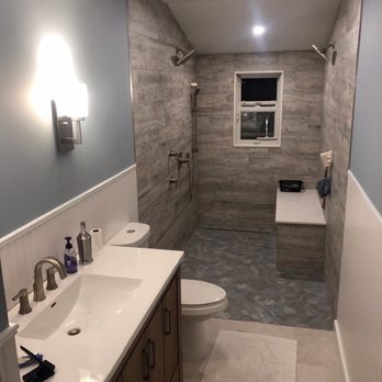 Murphy Construction - A 5'x8' bathroom became a 5'x17' bathroom by removing a support wall and extending the shower into the old Florida Room. - General Contractors Near Me - Oceanside, New York