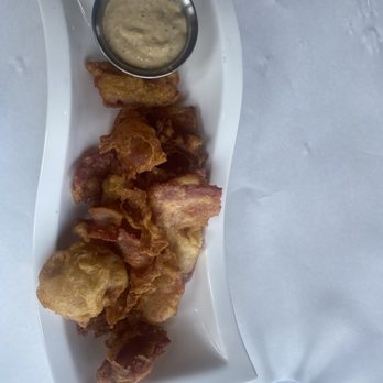 Amish Acres - Beer battered bacon pieces with garlic aioli sauce. - Hotels Near Me - Nappanee, Indiana Amish Acres - Beer battered bacon pieces with garlic aioli sauce. - Hotels Near Me - Nappanee, Indiana
