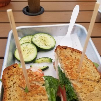The Weathervane Cafe - Italian Turkey on toasted gf bread, turkey, salami, provolone, pesto, fresh spinach, tomato. Ate some of the seasoned cucumbers - Coffee & Tea Near Me - Denver, Colorado
