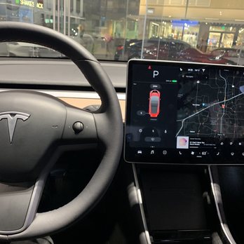 Tesla - Interior of the showroom's Model 3 and the front door/window - Car Dealers Near Me - Plano, Texas Tesla - Interior of the showroom's Model 3 and the front door/window - Car Dealers Near Me - Plano, Texas