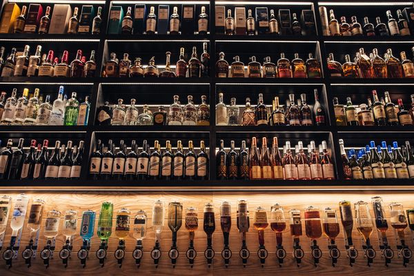 Photo of Brennan's - Saint Louis, MO, US. Brennan's shelves of spirits and wine.