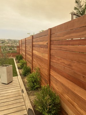 Custom Wood - Horizontal Fences and Gates - We build horizontal fences out of a variety of woods, including: Cedar, Redwood, Garapa, Mangaris, and Composite (think "Trex" material). If you have a particular wood you want to use, send it our way and we can let you know if that is a good option for a horizontal fence!