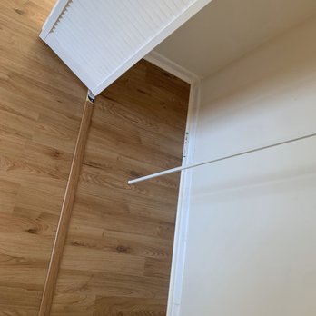 Cadet Home Improvement - a view of a kitchen with white cabinets and wood floors - General Contractors Near Me - Greenacres, Florida Cadet Home Improvement - a view of a kitchen with white cabinets and wood floors - General Contractors Near Me - Greenacres, Florida
