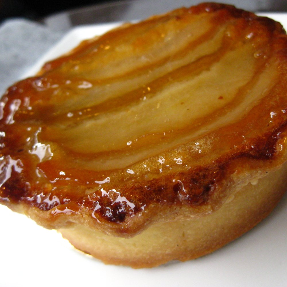 Faubourg - Pear Tart- Almond Frangipane on a candied hazelnut base - Bakeries Near Me - Vancouver, British Columbia Faubourg - Pear Tart- Almond Frangipane on a candied hazelnut base - Bakeries Near Me - Vancouver, British Columbia