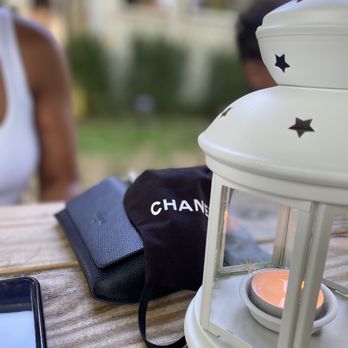 Old Stove Pub - a candle and a cell phone on a table - Steakhouses Near Me - Sagaponack, New York Old Stove Pub - a candle and a cell phone on a table - Steakhouses Near Me - Sagaponack, New York