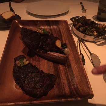 Bourbon Steak - Prime New York Strip on the bottom of platter and Australian Wagyu Tomahawk on the top platter after it was cut from the chef. - Steakhouses Near Me - Glendale, California Bourbon Steak - Prime New York Strip on the bottom of platter and Australian Wagyu Tomahawk on the top platter after it was cut from the chef. - Steakhouses Near Me - Glendale, California