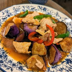 Thai Palace - E8. Pad Eggplant. $13.95. Pork (+$1) stir-fried with chili, garlic, bell peppers, Thai basil and eggplant. Comes with bowl of rice.