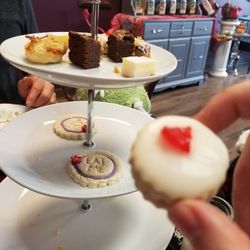 wonderland tea room and bake shop - Originally little squares, a tea biscuit, sandwiches; tuna, egg salad and cucumber. Also shredded cheese wrap and some sausage rolls.
