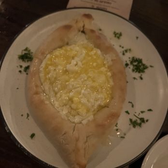 Babushka's - Hyde Park - Adjaruli Khachapuri - comes with a raw egg in top I had already mixed in before picture. Was tasty!! - Russian Near Me - Tampa Bay, Florida