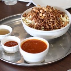 Egyptian Kitchen - Koshari Bowl ($15.99) - Egyptian national dish: rice, macaroni, lentil, chickpeas, fried onions. Served w/ tomato sauce, daa, shata
