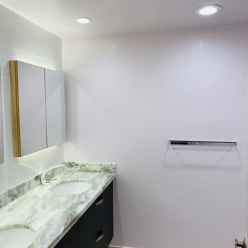 Guo Hong - a bathroom with two sinks and a mirror - General Contractors Near Me