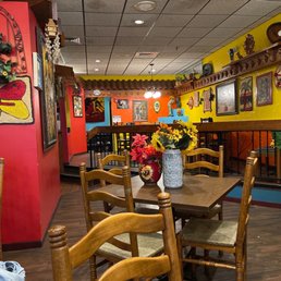 a dining area with tables and chairs a dining area with tables and chairs