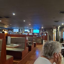 a woman sitting at a table in a restaurant a woman sitting at a table in a restaurant