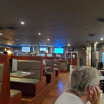 Village Inn - a woman sitting at a table in a restaurant - New American Near Me - Douglas, Wyoming Village Inn - a woman sitting at a table in a restaurant - New American Near Me - Douglas, Wyoming