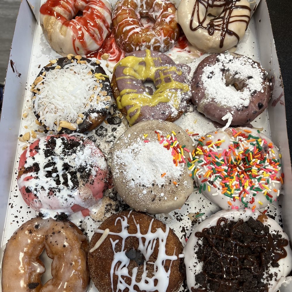 Duck Donuts - Dozen assorted box. The blueberry lemon (second row middle donut)  was my favorite from our box, but best donut goes to the beach ball - Donuts Near Me - Hilton Head, South Carolina